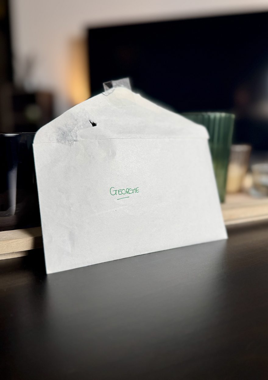 A worn envelope marked Georgie in green handwriting