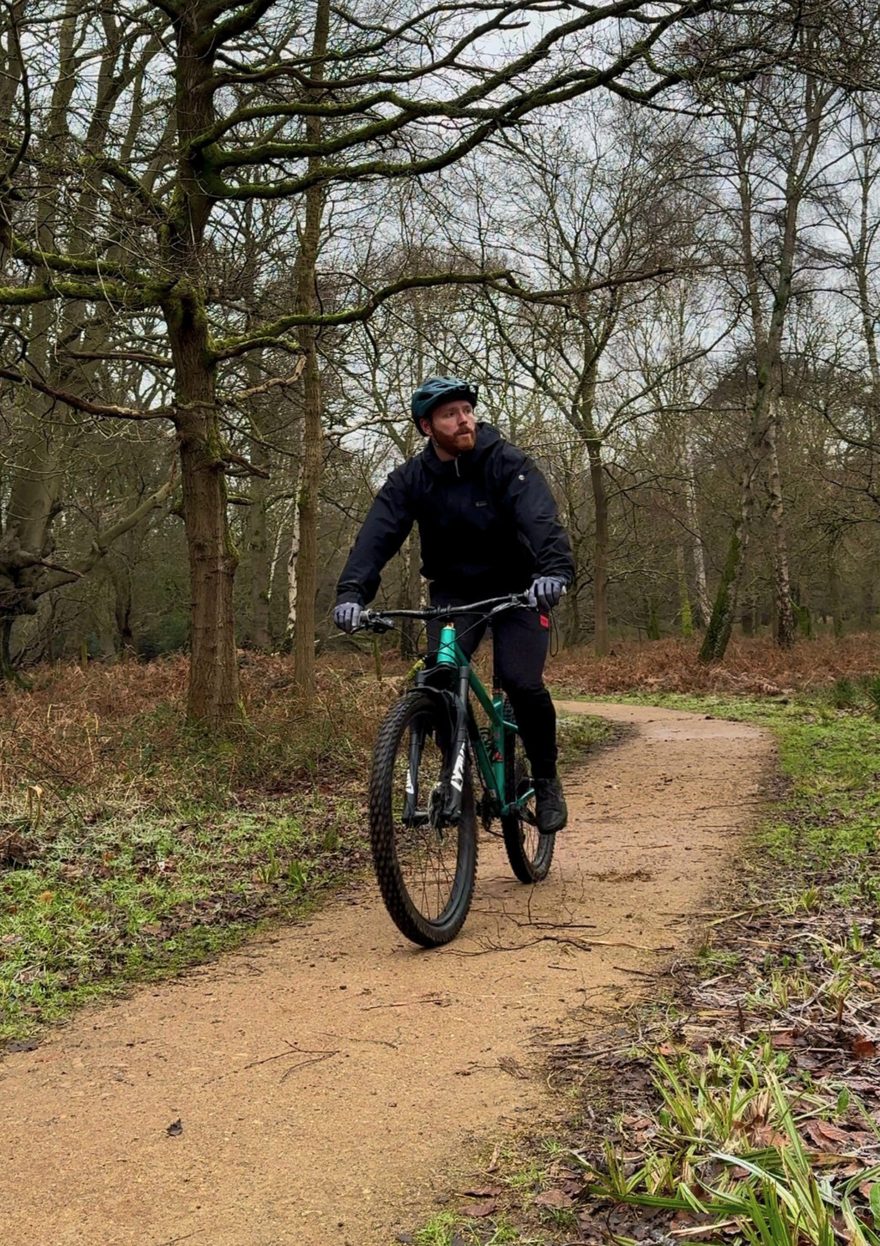 Dan riding a mountain bike on a woodland trail
